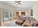 Comfortable living room with a leather sectional and ottoman adjacent to a dining area with wood cabinets at 13708 Old Dock Rd, Orlando, FL 32828