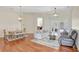 Bright and open living room with hardwood floors, neutral paint, and access to dining and patio at 13708 Old Dock Rd, Orlando, FL 32828