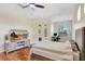 Bright primary bedroom offers wood floors, ceiling fan, access to the pool, and a desk area with a computer at 13708 Old Dock Rd, Orlando, FL 32828