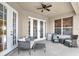 Outdoor patio features patio furniture, ceiling fan, and mini fridge at 13708 Old Dock Rd, Orlando, FL 32828