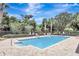 Outdoor pool with lounge chairs surrounded by lush trees at 13708 Old Dock Rd, Orlando, FL 32828