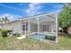 Backyard view of the screened-in pool and attached spa at 13708 Old Dock Rd, Orlando, FL 32828