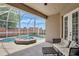 Covered patio view of the pool with attached spa and brick wall at 13708 Old Dock Rd, Orlando, FL 32828