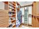 Organized walk-in closet featuring custom shelving, drawers, and hanging rods for optimal storage at 13708 Old Dock Rd, Orlando, FL 32828