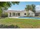 Backyard with a pool, grass, and mature trees at 2791 Citron Dr, Longwood, FL 32779