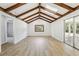 Bright, large bonus room with wood-look flooring, skylights, and sliding glass doors to patio at 2791 Citron Dr, Longwood, FL 32779