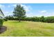 Grassy backyard with landscaping at 3550 Rodrick Cir, Orlando, FL 32824