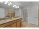 Bathroom with double vanity, granite counters, and separate toilet room for added privacy at 3550 Rodrick Cir, Orlando, FL 32824