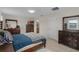 Comfortable bedroom featuring wood-look floors, neutral walls and stylish wood furniture at 3550 Rodrick Cir, Orlando, FL 32824