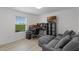 Bedroom offers natural light, a comfortable sofa, and dedicated workspace with multiple monitors at 3550 Rodrick Cir, Orlando, FL 32824
