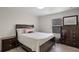 Cozy bedroom featuring a full size bed, wood floors, and natural light from the window at 3550 Rodrick Cir, Orlando, FL 32824