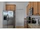 Kitchen featuring stainless steel refrigerator, granite countertops, and ample cabinet space at 3550 Rodrick Cir, Orlando, FL 32824