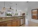 Kitchen featuring granite countertops, stainless steel appliances, and a breakfast bar overlooking the living area at 3550 Rodrick Cir, Orlando, FL 32824