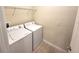 Laundry room with a washer and dryer set plus overhead shelving at 3550 Rodrick Cir, Orlando, FL 32824