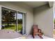 Covered patio with sliding glass doors and a comfortable rocking chair at 3550 Rodrick Cir, Orlando, FL 32824