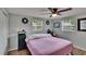 Welcoming bedroom with ceiling fan, two windows, wood-look floors and ample closet space at 4145 Willow Oak Rd, Mulberry, FL 33860