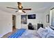 Bright bedroom featuring a ceiling fan, closet, desk, and a wall-mounted television at 4145 Willow Oak Rd, Mulberry, FL 33860