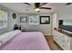 Bright bedroom featuring a ceiling fan, wood-look flooring, and a large window at 4145 Willow Oak Rd, Mulberry, FL 33860