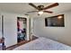 Bright bedroom with a large closet, ceiling fan and a wall-mounted television at 4145 Willow Oak Rd, Mulberry, FL 33860
