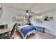Cozy bedroom with a ceiling fan, wood-look floors, and a bed with a blue throw at 4145 Willow Oak Rd, Mulberry, FL 33860