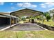 Spacious carport providing covered parking and a view of the surrounding yard at 4145 Willow Oak Rd, Mulberry, FL 33860