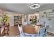 Comfortable dining room with wood floors, white chairs, a round table, and stylish decor throughout at 4145 Willow Oak Rd, Mulberry, FL 33860