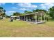 Charming home exterior with a spacious yard and screened porch, ideal for outdoor enjoyment at 4145 Willow Oak Rd, Mulberry, FL 33860