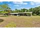 Home exterior with a spacious backyard and screened porch, perfect for outdoor entertaining at 4145 Willow Oak Rd, Mulberry, FL 33860