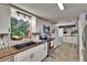 Updated kitchen features sleek countertops, stainless steel appliances, and a window with natural light at 4145 Willow Oak Rd, Mulberry, FL 33860