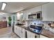 Updated kitchen showcases stainless steel appliances, sleek countertops and a functional open floorplan at 4145 Willow Oak Rd, Mulberry, FL 33860