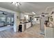 Bright kitchen boasts white cabinets, stainless steel appliances, and open layout to the living room at 4145 Willow Oak Rd, Mulberry, FL 33860
