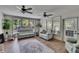 Sun-filled living room with updated flooring, large windows, and plush seating arrangements at 4145 Willow Oak Rd, Mulberry, FL 33860