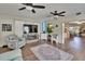 Cozy living room with ceiling fans, a decorative fireplace, and seamless access to other spaces at 4145 Willow Oak Rd, Mulberry, FL 33860