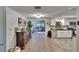 Open-concept living area with wood floors, a modern kitchen, and a view into a cozy sitting room at 4145 Willow Oak Rd, Mulberry, FL 33860