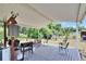 Outdoor patio area featuring a barbecue, dining set, and ample seating space overlooking the yard at 4145 Willow Oak Rd, Mulberry, FL 33860