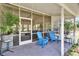 Inviting screened-in patio features blue Adirondack chairs overlooking the lush yard at 4145 Willow Oak Rd, Mulberry, FL 33860