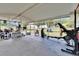 Large covered porch with exercise equipment and outdoor storage overlooking the backyard at 4145 Willow Oak Rd, Mulberry, FL 33860