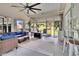 Relaxing sunroom includes comfortable wicker seating, a ceiling fan, and access to the yard at 4145 Willow Oak Rd, Mulberry, FL 33860