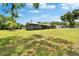 Sprawling front and side yard, featuring a well-maintained lawn and mature trees in a tranquil setting at 4145 Willow Oak Rd, Mulberry, FL 33860