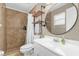 This bathroom features a walk-in shower with tile surround and a modern vanity with round mirror at 455 W Plumosa St, Bartow, FL 33830