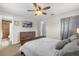 Comfortable bedroom boasts a dresser, TV, and attached bathroom at 455 W Plumosa St, Bartow, FL 33830