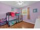 Cozy ' bedroom with laminate floors, ceiling fan, and playful decor at 455 W Plumosa St, Bartow, FL 33830