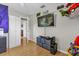 Cozy bedroom with built-in shelves, gaming-themed decor, and wood floors at 455 W Plumosa St, Bartow, FL 33830