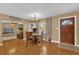 Inviting dining room with an open floor plan and hardwood floors, adjacent to the living area at 455 W Plumosa St, Bartow, FL 33830