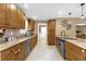 Charming kitchen featuring wood cabinets, granite countertops, mosaic backsplash and stainless steel appliances at 455 W Plumosa St, Bartow, FL 33830