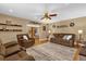 Comfortable living room featuring wood floors, a ceiling fan, and cozy couches at 455 W Plumosa St, Bartow, FL 33830