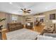 Relaxing living room with ceiling fan, wood floors, and dining room access at 455 W Plumosa St, Bartow, FL 33830