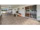 Large screened-in patio with brick flooring and access to the backyard at 455 W Plumosa St, Bartow, FL 33830