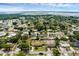 A landscape aerial view of the property in a neighborhood featuring a screened-in pool and serene lakeside views at 4727 Wales St, Lake Wales, FL 33859