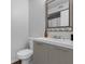 Modern bathroom with a sleek vanity, toilet, and illuminated mirror at 4727 Wales St, Lake Wales, FL 33859